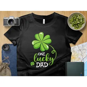 Women's St. Patrick's Day celebration and fatherhood Graphic T-Shirt - Short Sleeve Crew Neck Regular Fit Casual Wear | Soft & Breathable Fabric, Durable Print, Everyday Comfort, Machine Washable, flat lay with lifestyle props A flat lay composition