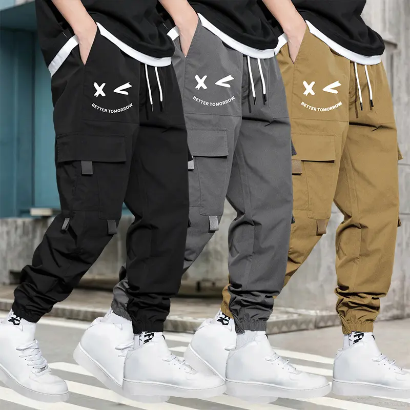 Men’s cargo jogger pants with multiple pockets, letter print, elastic waistband with drawstring, large side cargo pockets, functional webbing detailing, trendy jogger cargo pants, available in multiple colors