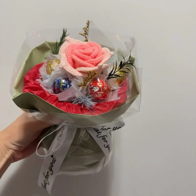 Crocheted flower bouquet mixed with chocolate elements, chocolate bouquet