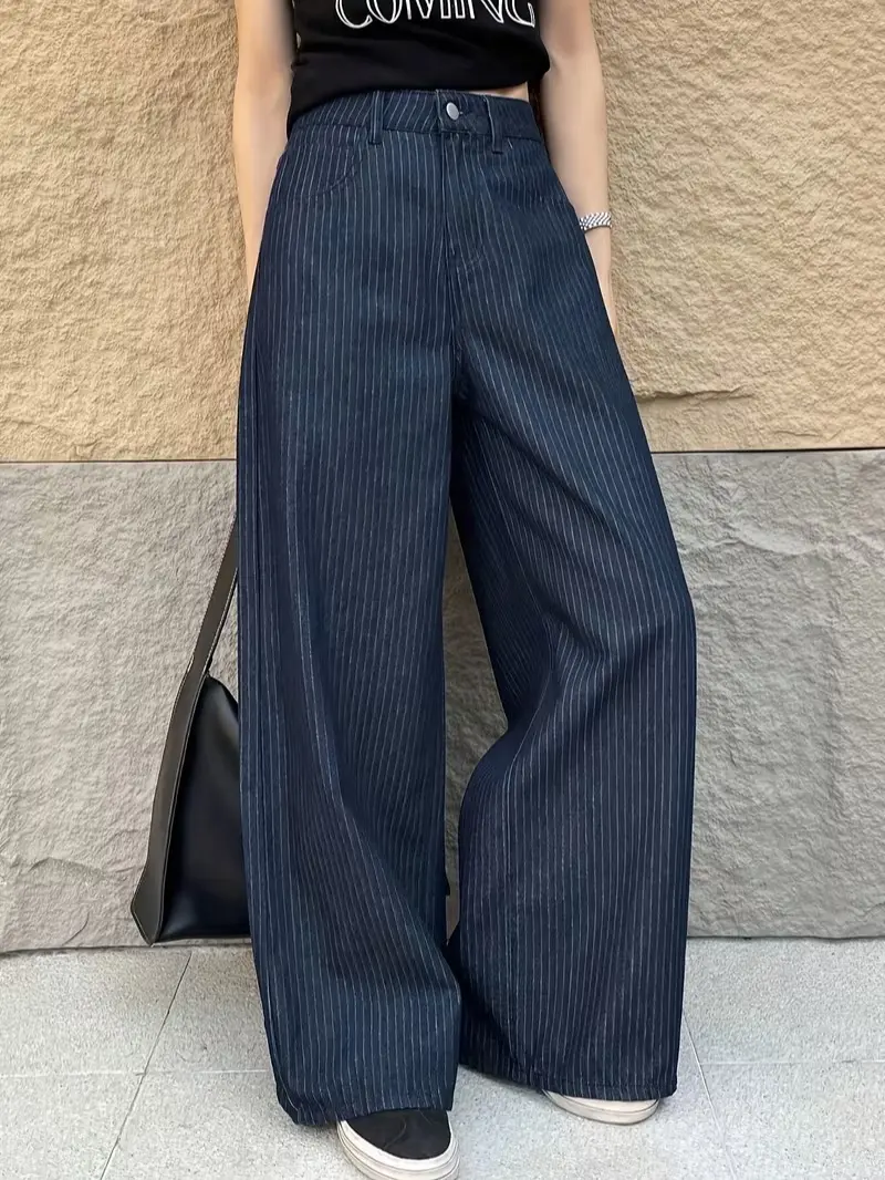 One piece women’s wide leg jeans featuring navy blue vertical stripes, a button closure, and a high waist; urban casual style with fine white vertical texture paired with classic hardware at the waistband. Suitable for everyday commuting, shopping, and ex