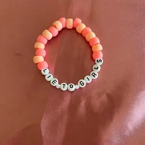 Lie To Girls Bracelet SC Collection - Beaded Bracelet with "LIE TO GIRLS" Text, Orange Beads, and White Accents