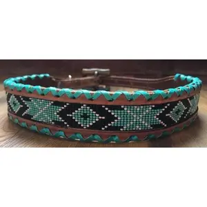 Genuine leather dog collar with teal, white, and black southwest beaded inlay design, a rawhide wrapped edge