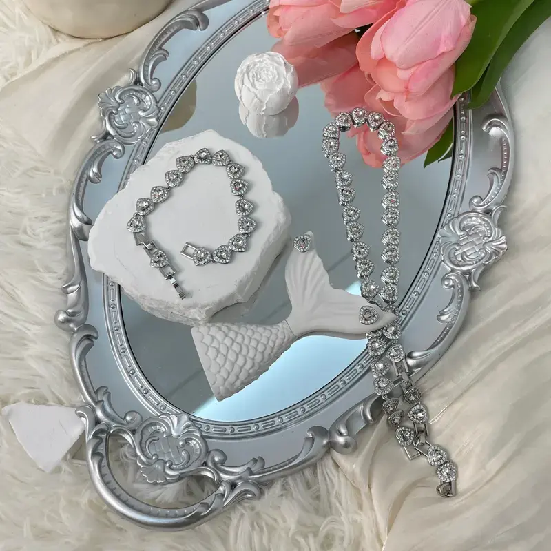 Women's silver heart-shaped jewelry set featuring a delicate, adjustable heart-link design; includes a sparkling silver necklace and an adjustable bracelet—an ideal gift for Valentine's Day, birthdays, or weddings.