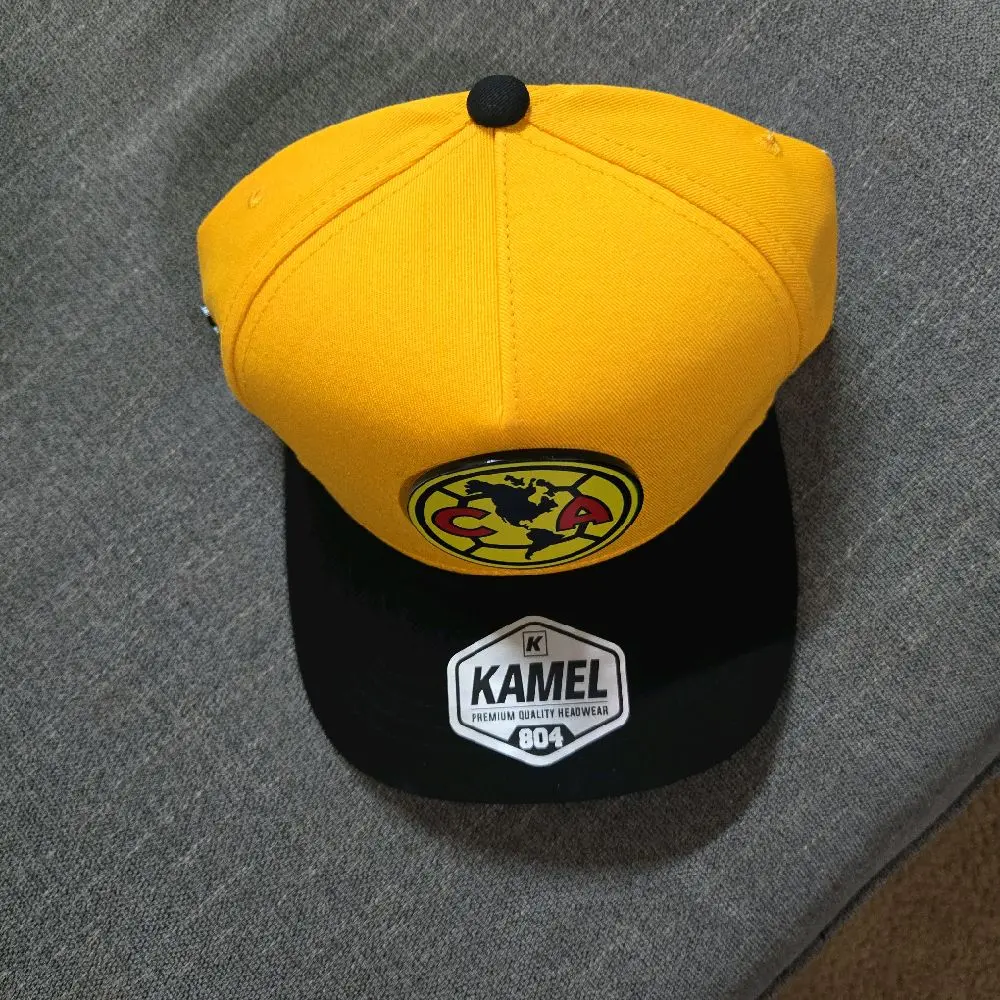 Gorra america color amarillo visera obscura marca kamel ajustable