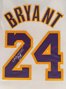Framed  Facsimile Autographed Kobe Bryant #24 White Player-Issue Retro Basketball Jersey Brushed Metal Engraved Nameplate, Iconic Game Photo, Premium Patterned Matting, Dual-Sided Display (Black & Gold / Purple & Gold Design), Original Frame Design