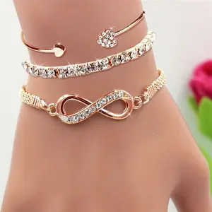 A Set of Three Women'S Bracelets And Bangles Featuring Wireless Symbols And Heart Designs Adorned with Rhinestones.