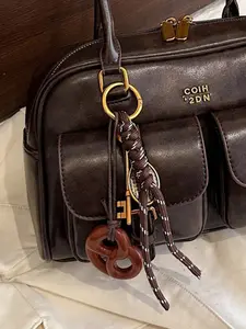 A niche alkaline water knot pendant with a retro and exquisite fashion, featuring woven ropes, keys, rackets, and other elements, convenient and easy to carry, can be used as a keychain, bag decoration, etc