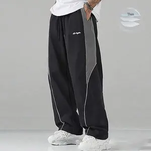 Men’s black base color contrast sweatpants with white side stripes and embroidery; casual fitness wear; loose-fit joggers; trendy street-style running pants; drawstring waistband; straight cut; polyester fabric – SpringStatements