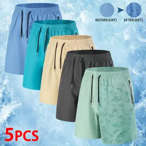 Mens 5 Pack Vacation Ready Shorts Showcasing Cool Water Activated Graphics with Hidden Beach Inspired Motifs That Appear When Wet Ultra Comfortable Quick Dry Fabric Perfect for Summer Trips and Outdoor Fun