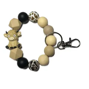 Tan Cow Keychain with Unique Bead Design and Animal Print Accents