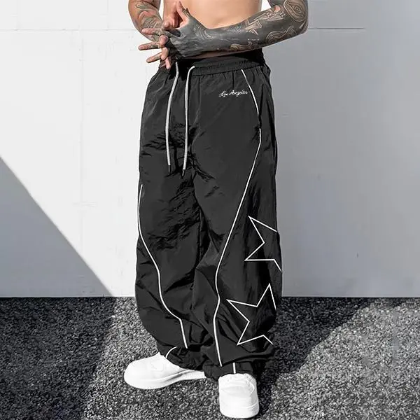 Men’s star print wide-leg athletic pants made from lightweight, breathable nylon fabric, featuring an elastic drawstring waist and contrasting piping; a versatile choice for Y2K street style, skateboarding, everyday wear, and summer outfits. fathersdaygif