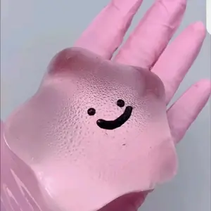 Smiley Stress Ball - Pink Gloved Hand Holding a Unique Smiling Face Design Product