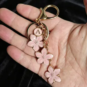 There are 26 letters to choose from,Women's letter A keychain cherry blossom keychain crossbody bag simple backpack student girl backpack plum blossom flower mobile phone handbag decoration pendant