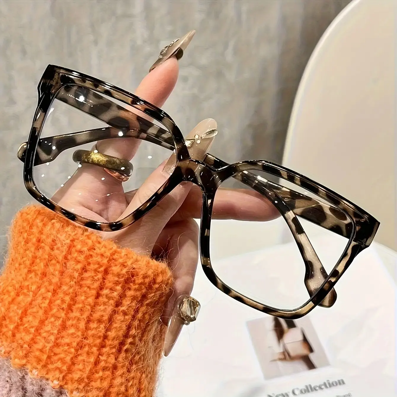 A pair of square, clear glasses designed specifically for women, adorned with a stylish, randomly distributed leopard print pattern.