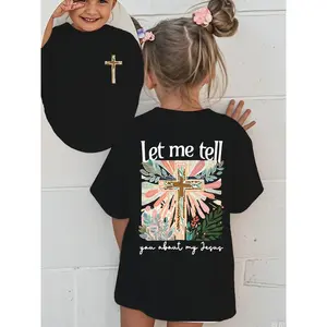 Colorful Graphic Black T-Shirt for Girls - Features Floral Cross Design and Inspirational 'Let me tell you about my Jesus' Text | Adorned with Pink Hair Clips, Perfect for Casual Wear | Stylish and Eye-Catching Top for Young Fashionistas