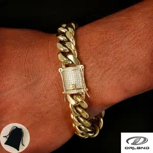 Oran Cuban Link Bracelet, crafted from stainless steel with K-gold vacuum nano-plating and featuring a unique clasp adorned with cubic zirconia. Chain width: 6–14 mm, Length: 7.5–8.5 inches. Hypoallergenic, with a heavy, rugged texture.