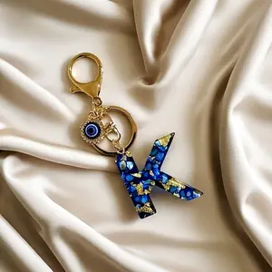 One Blue Resin Keychain, Keychain Jewelry, Featuring an Evil Eye Design, Rectangle Shaped with an Alphabet Initial Charm, This Accessory for Women Includes a Lobster Clasp, Making It a Gift for Ramadan, And Serves As a Decorative Key Ring for Ba