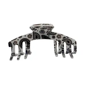 The Whitney Black & White Bandana print claw clip with classic paisley details for a bold, vintage-inspired touch designed for adjustable hats