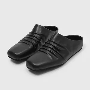 Unisex smooth leather ruched square-toe slip-on mules with no heel, one-piece pull-on design and low flat sole—minimalist avant-garde everyday casual slides