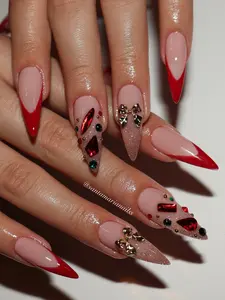 Bubble Nailart | Red Bow Gem nude pink gel press on nails with bright red French tips, rose gold glitter accent nails, 3D gold bow charms and red green rhinestones long stiletto shape, handmade, reusable, luxury Press On Nails, Fake Nails Gel Nail,