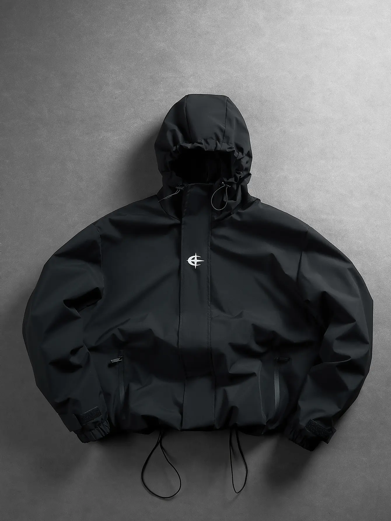 Unisex minimalist black tech hooded windbreaker — dark high street outdoor style, waterproof quick dry fabric, abstract star chest print, dual sealed zip pockets, drawstring hood and hem, Velcro cuffs; a trendy jacket for hiking, skateboarding, and street