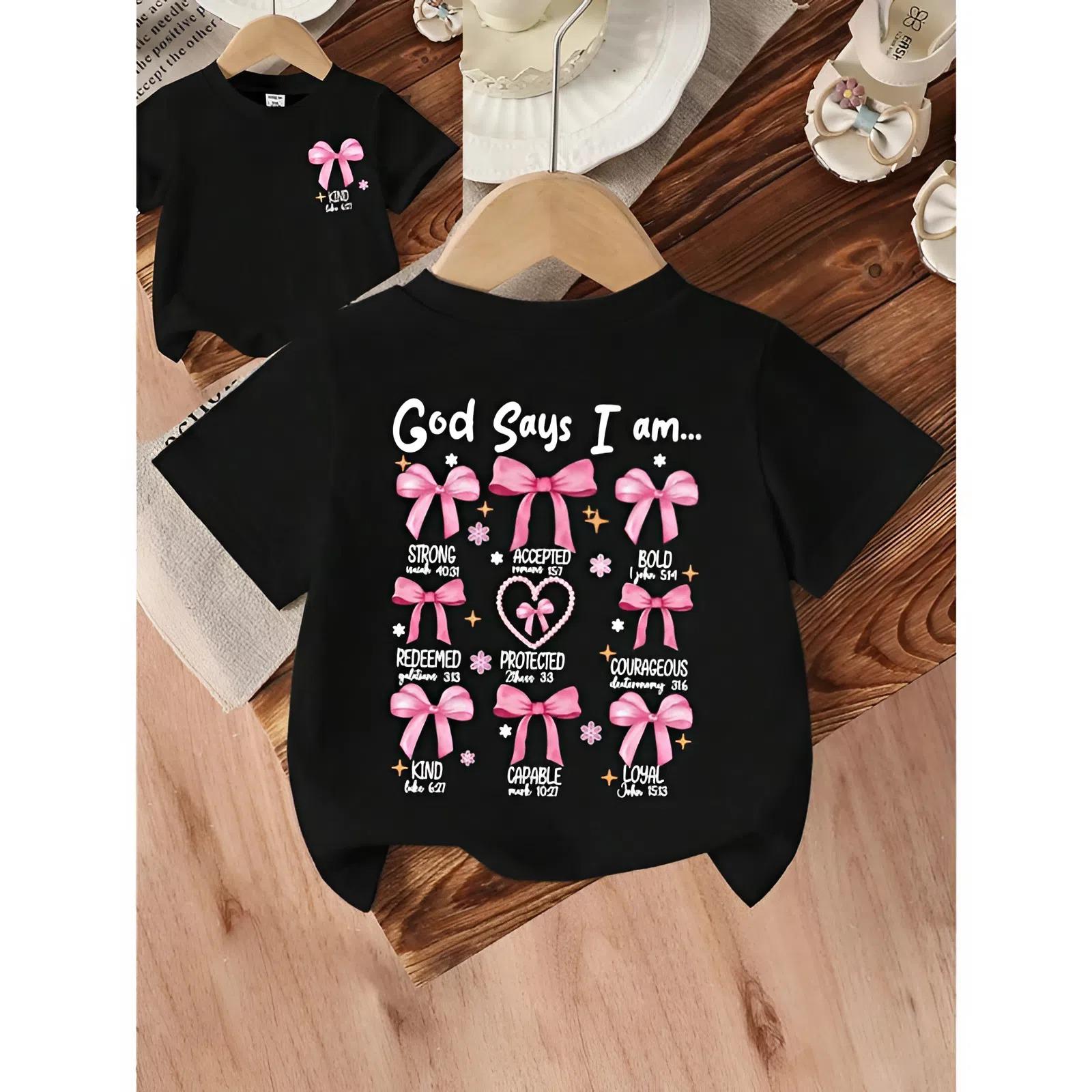 Youth Girls’ “God Says I Am Strong” Bow, Pearl, Heart Print Round Neck Short Sleeve Cute Black T-Shirt, Trending tee, youth clothing, Family shirt, gift for son and daughter, Jesus Lover Gift, funny shirt