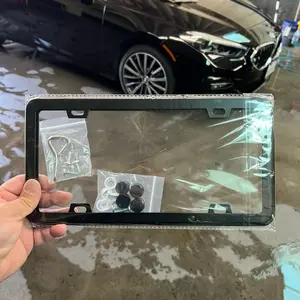 Set of two flat black license plate frames with hardware kit.