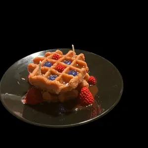 Belgian Waffles with Fresh Berries and Blueberries Topped with Syrup.