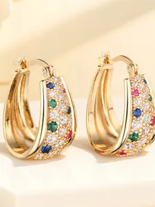 A pair of geometric design statement earrings made of synthetic colored crystals, stylish and retro gold, perfect for wearing on special occasions like weddings.