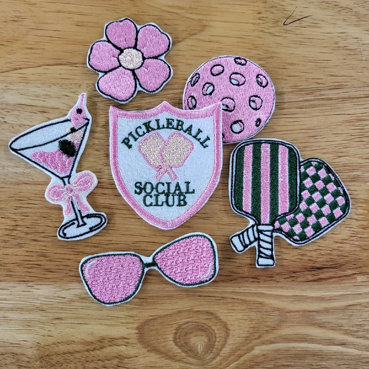 Set of 6 iron on Pickleball themed Embroidered patches  in pink and green. Martini glass, pickleball and paddles, sunglasses, Pickleball Social Club, and flower patches included.