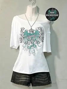 Must-Have 2026 Alt Fashion Top! Off-Shoulder Black Tee W/ Turquoise Heart Wing & Star Print | Non-Rhinestone Edgy Design | Y2K Retro Grunge Style | Trendy Casual Streetwear Aesthetics #AlternativeFashion #Y2KTrends #GrungeStyle