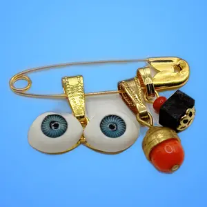 Azabache protection pin with Blue Santa Lucia eyes and peonia