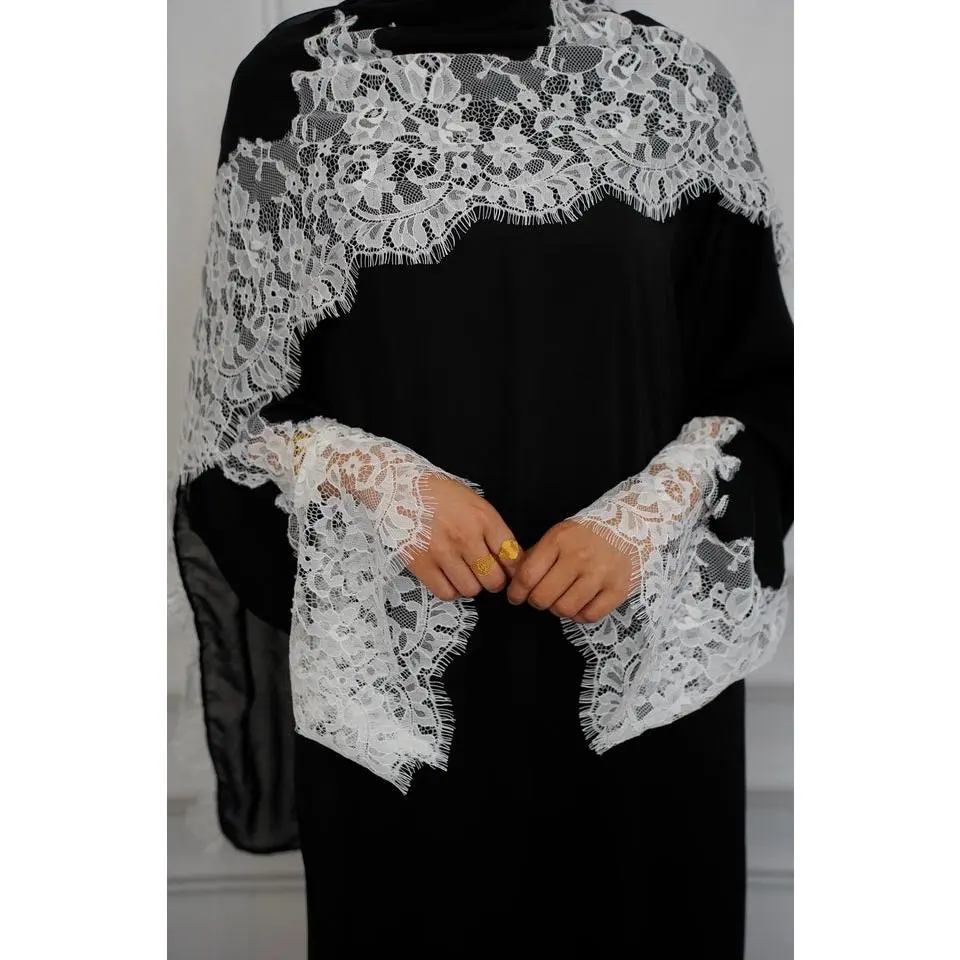 Maya Lace Abaya is a closed black abaya with soft white lace on the  sleeves. It has a flowy, modest fit and comes with a matching hijab. Simple, elegant, and perfect for any occasion.