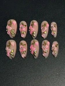 Cute Almond Nails with Pink Flowers and Gold Accents for Stylish Manicures