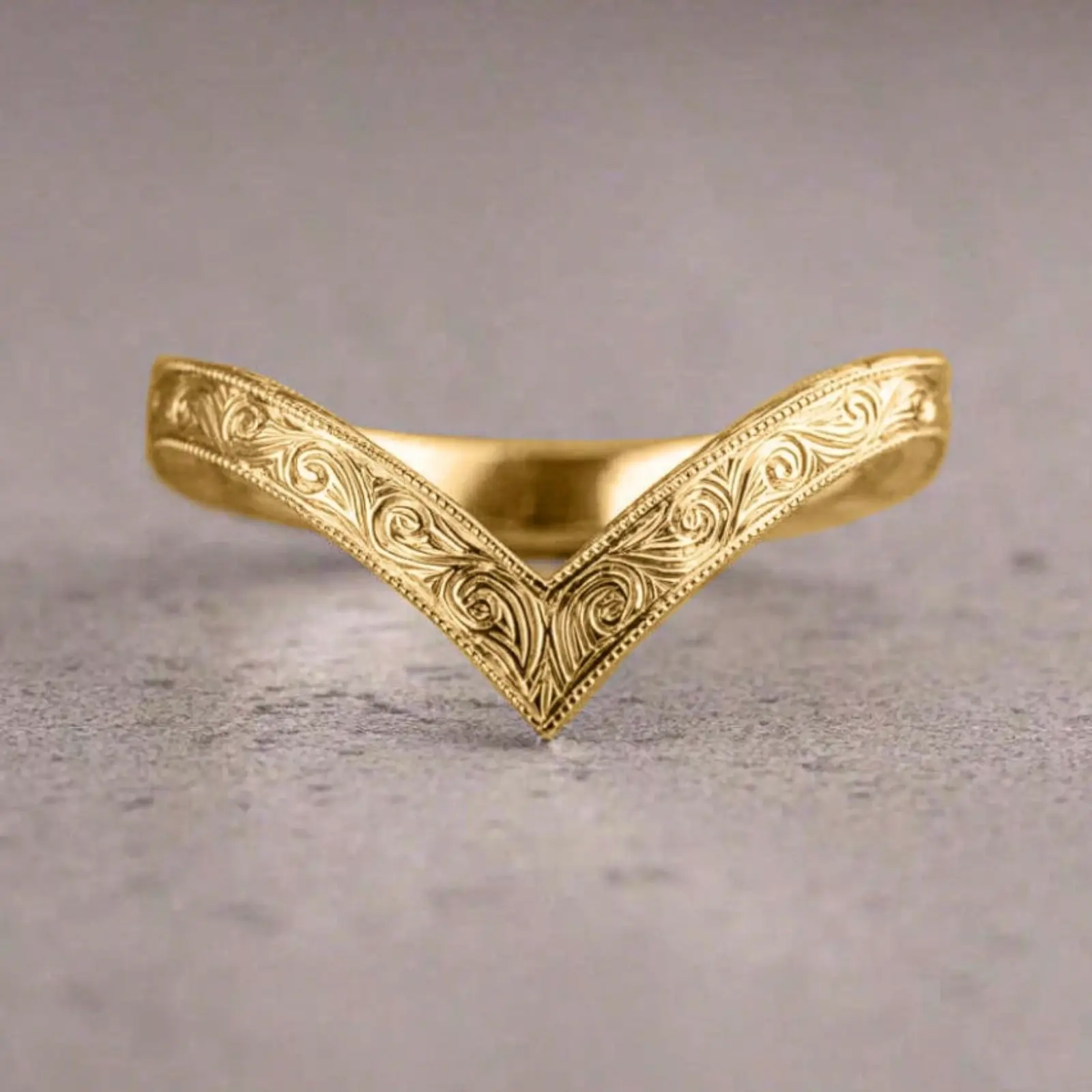 A fashionable 18k gold-plated ring with a spiral V-shaped design and delicate floral engraving, perfect for women to wear daily, to parties, anniversaries, or as a holiday gift.