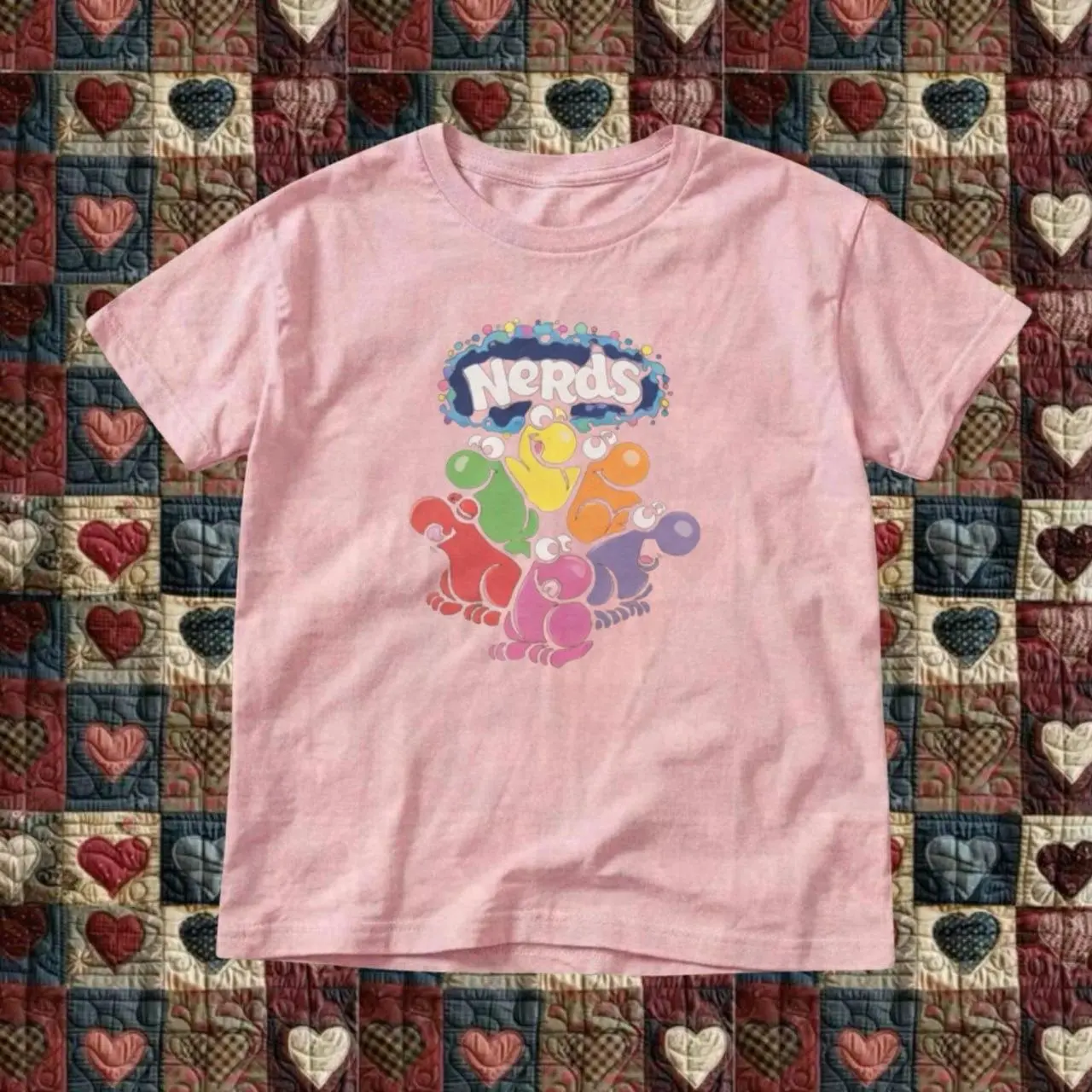 Pink Nerds candy graphic tee with multicolored cartoon characters