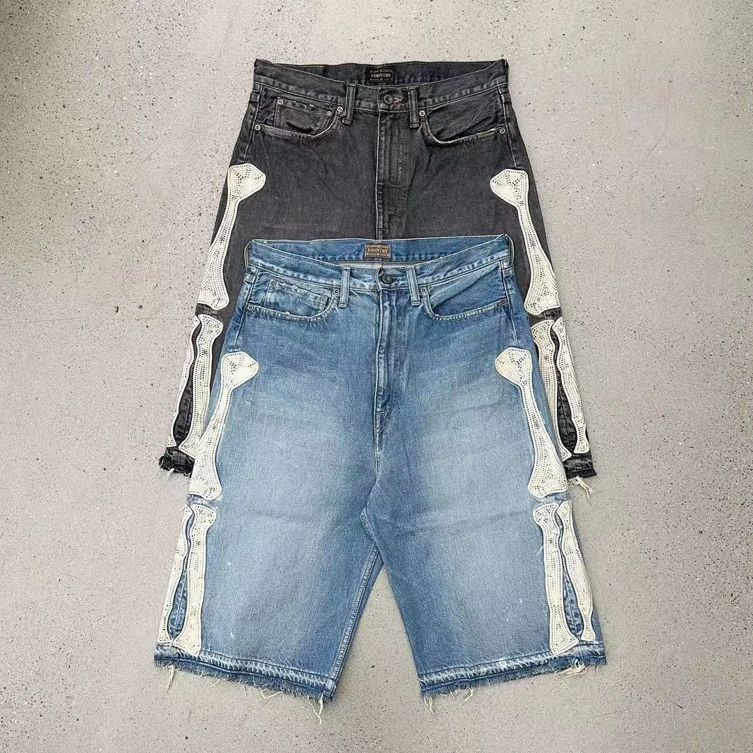 Retro nostalgia meets avant-garde design! Denim mid-length shorts with a bone-texture design-detail lovers will go wild! Made using a washed distressed process, both black and blue have a vintage faded look.