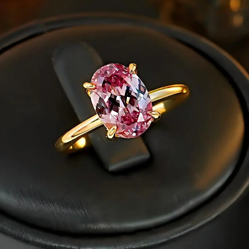 A single diamond in a pigeon egg shape, comparable to the ice-flower cut, with a high-end, minimalist design, and flattering, in a gold color, open ring, rose red
