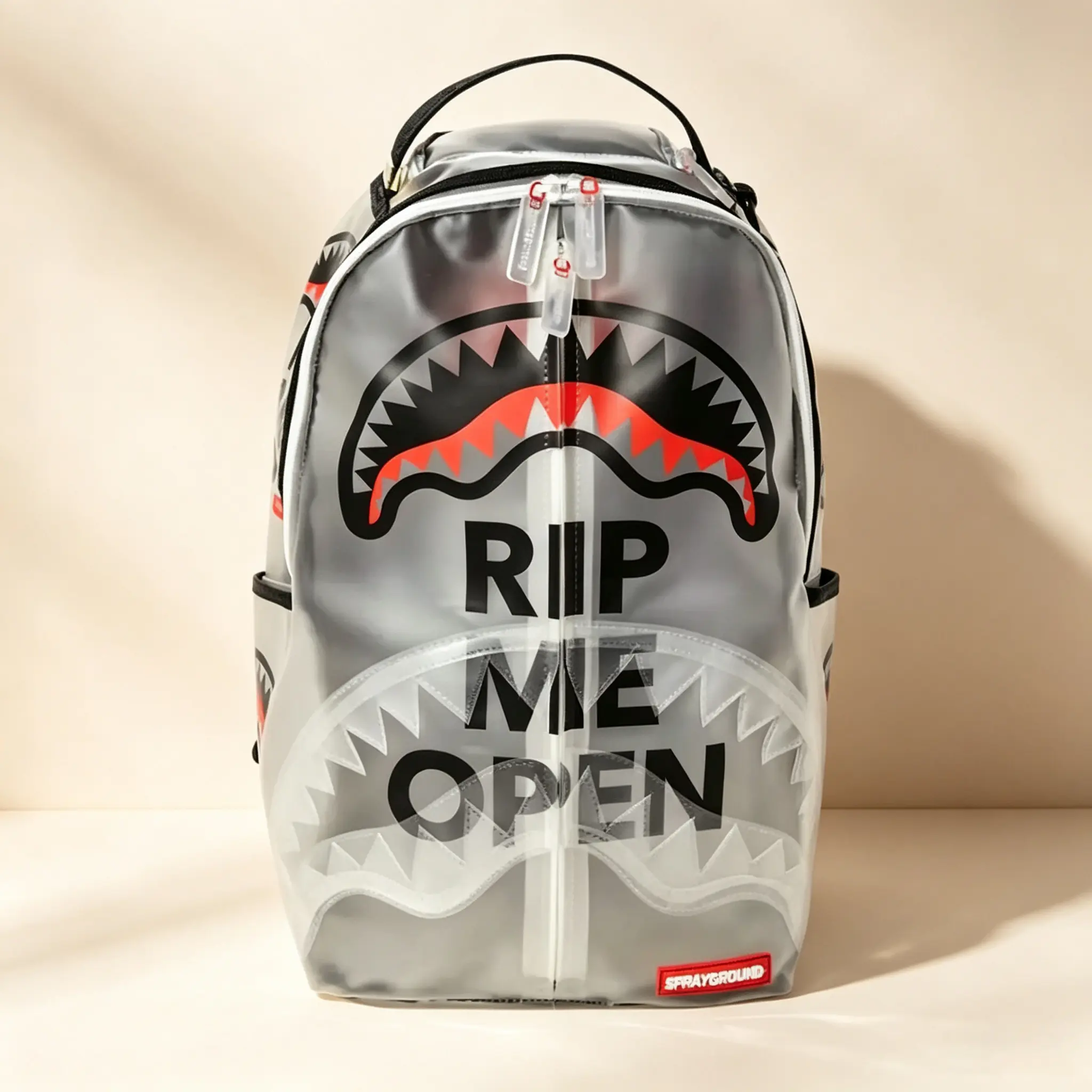 Sprayground Rip Me Open Backpack - Transparent Design with Bold Shark Mouth Print and "Rip Me Open" Text