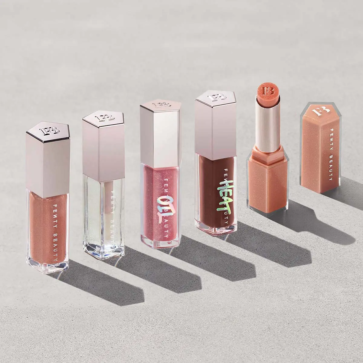 Fenty Beauty 5-Piece Lip Gloss Vault: Gloss Bomb Lip Luminizer, Gloss Bomb Heat Lip Luminizer + Plumper, Gloss Bomb Oil Luminizing Lip Oil 'N Gloss, Gloss Bomb Stix Shimmer High-Shine Gloss Stick