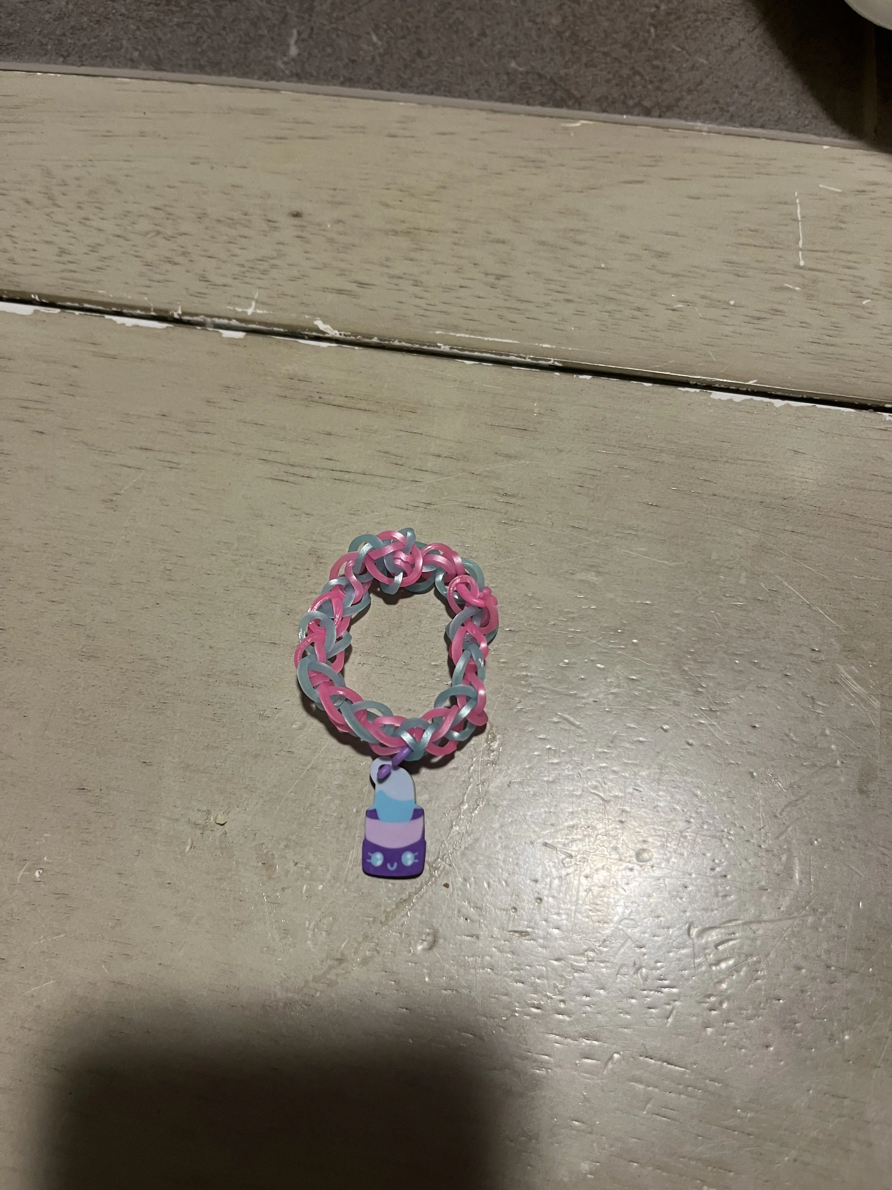 Handmade rubber band bracelet customizable with different colors, beads, and charms
