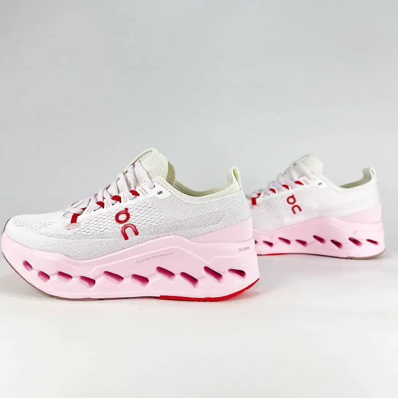 Lightweight woven athletic shoe white knit upper hollow carved pink midsole red rubber tip shock‑absorbing sole daily jogging footwear