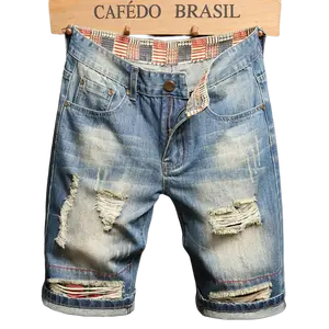 Grunge vintage distressed denim shorts with frayed details and rolled cuffs
