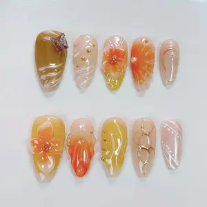 Handmade mid-length decorative nail stickers in a simple French-style flower design for nail art. Finished nail art with almond-shaped nails