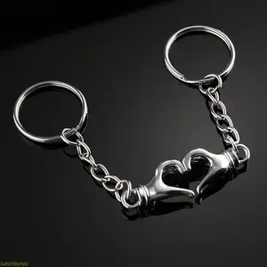 Couple keychains – featuring a simple, interlocking "key of love" design and romantic matching pendants, suitable for bags, backpacks, or keychains.