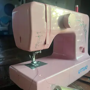 Brand new, un-used pink Sewing machine clothing decoration homemaking with tons of threads. Everything you need! 15 different stitches Extention Table Automatic Stitches