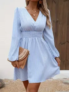 A women's light blue Lightweight Woven fitted bodice with a V-neck and A-line skirt dress, featuring a slimming and refreshing beach style Spring