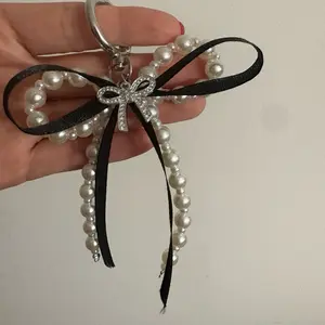 Bow Keychain with Pearl Decor and Black Ribbon Attachment