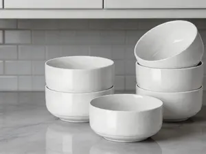 6-piece white ceramic bowl set, 20 oz capacity each. Multipurpose bowls for cereal, soup and rice. Stackable stoneware design for modern kitchens, safe for microwave and dishwasher use.