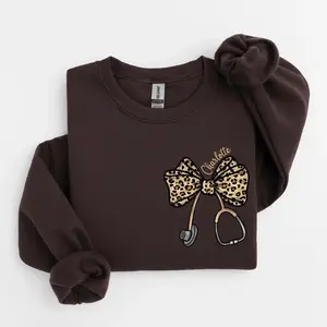 (Ship from US) [Custom Name] Leopard Stethoscope Bow Sweatshirt, Coquette Nurse Hoodie, Nurse Appreciation Gift, Nursing Student Sweatshirt, Healthcare Sweater